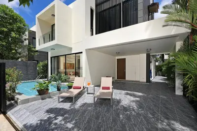 an external view of a house with a swimming pool at 5 bdr Pool Villa Bang Tao Beach in Laguna Phuket