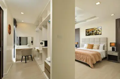 a bedroom with a bed and a desk and a sink at 5 bdr Pool Villa Bang Tao Beach in Laguna Phuket