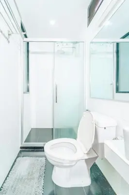 a white bathroom with a toilet and a shower at Rich Pool Villa Phang Nga in Khok Kloi