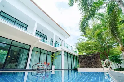 a house with a swimming pool in front of it at Rich Pool Villa Phang Nga in Khok Kloi