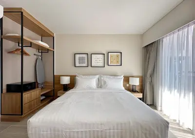 a bedroom with a large white bed and a window at Laguna Lakeside in Bang Tao Beach
