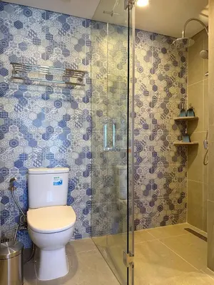 a bathroom with a toilet and a glass shower at Laguna Lakeside in Bang Tao Beach