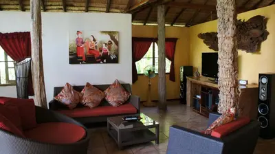 a living room with a couch and a tv at Cliffside Lagoon Villa in Ao Nang Beach