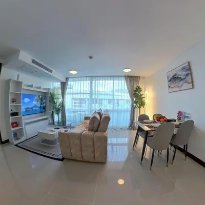 a living room with a couch and a table at The Kris Residence Two Bedrooms Apartment in Patong Beach