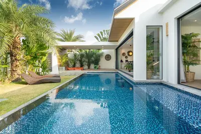 a swimming pool in the backyard of a villa at Villa Kalliste Phuket - Lush Garden Escape in Nai Yang Beach