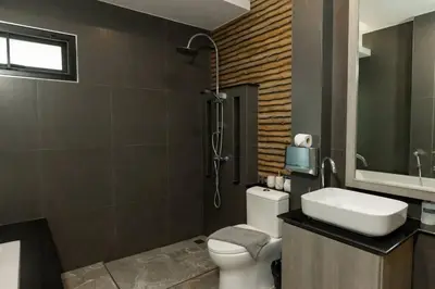 a bathroom with a toilet and a shower and a sink at Udomsuk Pool Villa Krabi in Ban Khlong Haeng
