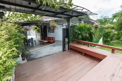a wooden deck with a bench and a pergola at Udomsuk Pool Villa Krabi in Ban Khlong Haeng