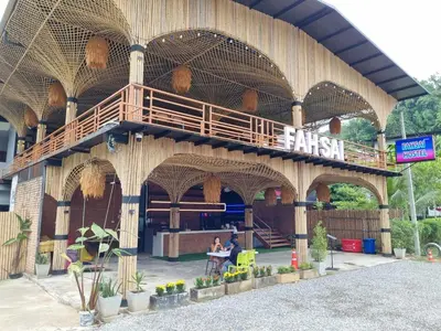 a building with a deck on the side of it at Fahsai Hostel in Ao Nang Beach