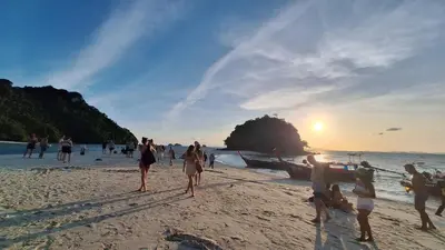 a group of people on the beach at sunset at Fahsai Hostel in Ao Nang Beach