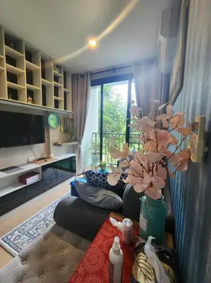 a living room with a vase with a plant in it at Stylish condo near Boat Avenue LAGUNA in Bang Tao Beach