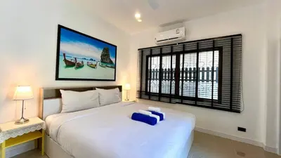 a bedroom with a large white bed and a window at Bayok 10 - 2 Bedroom Villa Near Kathu Waterfall in Ban Huai Luk (1)