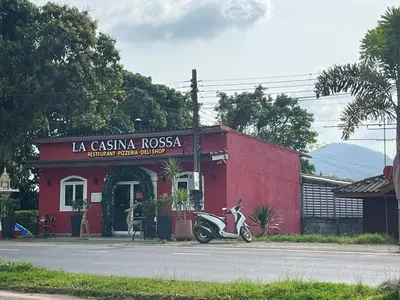 a scooter parked in front of a red building at Bayok 10 - 2 Bedroom Villa Near Kathu Waterfall in Ban Huai Luk (1)