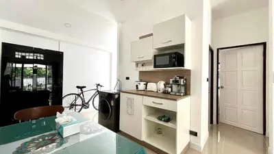 a kitchen with a table and a microwave in a room at Bayok 10 - 2 Bedroom Villa Near Kathu Waterfall in Ban Huai Luk (1)