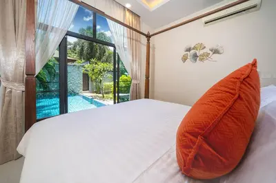 a bedroom with a bed with a large window at Onyx 2 br private pool Rawai in Ban Saiyuan (1)