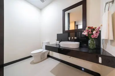a bathroom with a sink and a toilet and a mirror at Onyx 2 br private pool Rawai in Ban Saiyuan (1)
