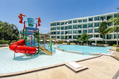 a pool with a water slide in front of a building at Apart Close to the Beach Sea view in Rawai Beach