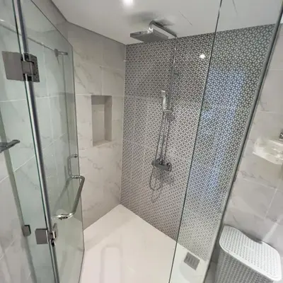 a shower with a glass door in a bathroom at Cassia Phuket laguna 1 BDR in Laguna Phuket
