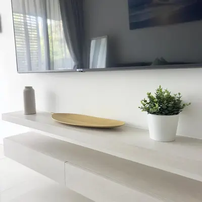a wooden plate on a counter with a potted plant at Cassia Phuket laguna 1 BDR in Laguna Phuket