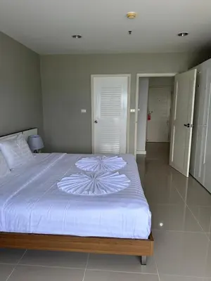 a bedroom with a large bed with a white comforter at Patong Tower sea view 2B in Patong Beach