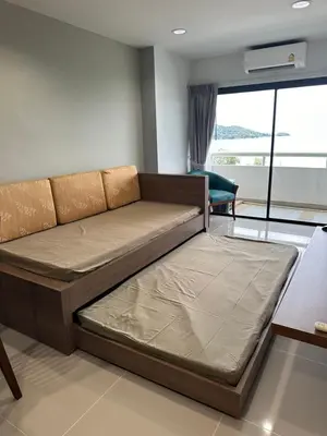 a large bed in a room with a window at Patong Tower sea view 2B in Patong Beach