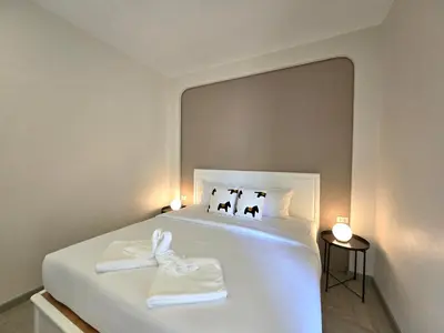 a bedroom with a white bed with a large mirror at Hommory Residence - East Chalong in Phuket Town