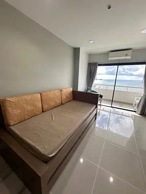a couch in a living room with a view of the ocean at Patong Tower Apartments sea view 2B in Patong Beach