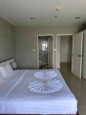 a large white bed with a flower design on it at Patong Tower Apartments sea view 2B in Patong Beach