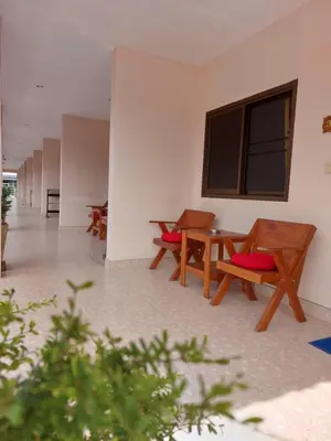 a room with benches and a table and a window at Smile house in Karon Beach