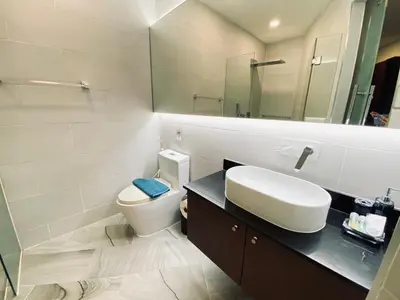 a bathroom with a toilet and a sink and a mirror at A11 Oceana Kamala in Kamala Beach