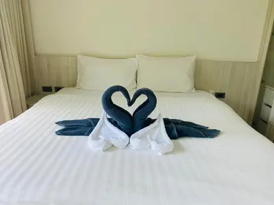 a bed with two swans in the shape of a heart at A26 Oceana Kamala in Kamala Beach