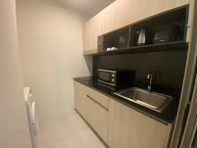 a kitchen with a sink and a microwave at A43 Oceana kamala in Kamala Beach