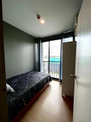 a bedroom with a bed and a balcony at ZcapeX2 condominium in Bang Tao Beach