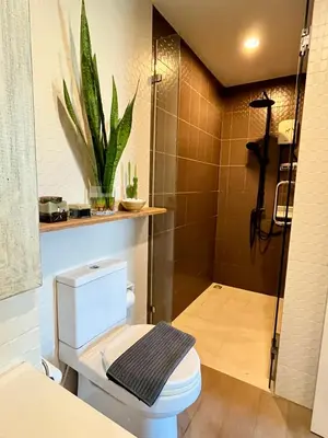 a bathroom with a toilet and a shower at ZcapeX2 condominium in Bang Tao Beach