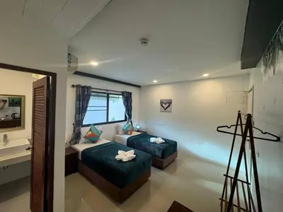 a bedroom with two beds and a camera at Pupa Rooms in Patong Beach