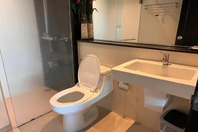 a bathroom with a toilet and a sink at JZ Patong in Patong Beach