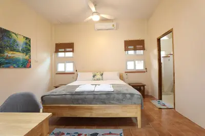 a bedroom with a bed and a ceiling fan at Coral Lagoon Pool Villa Rawai - Adult Only in Rawai Beach