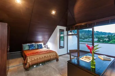 a bedroom with a bed and a desk at 23 - Seaside Villa Retreat in Phuket Town