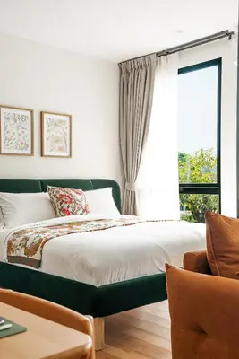 a bedroom with a bed and a window at Title Halo Time for Jungle 40m2 King Bed Pool in Nai Yang Beach