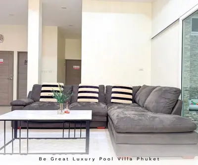 a living room with a couch and a coffee table at Luxury Pool Villa 5 mins to Phuket Old Town in Ban Lo Long