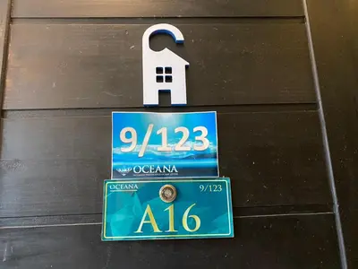 a sign on a wooden door with a number on it at A16 Oceana Kamala in Kamala Beach