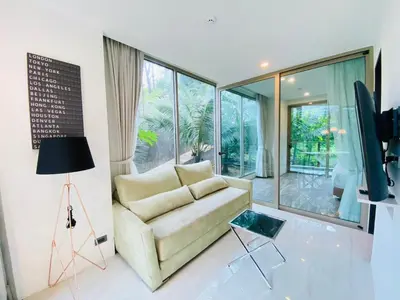 a living room with a couch and a tv at A16 Oceana Kamala in Kamala Beach