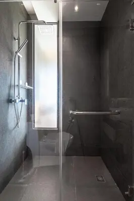 a shower with a glass door in a bathroom at Studio Sora Rooftop Pool ReLife Nai Harn Beach in Rawai Beach