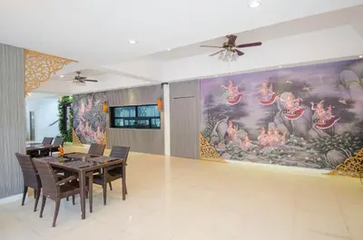 a dining room with a large painting on the wall at Golden Manora Hotel Bangtao Beach Phuket in Bang Tao Beach