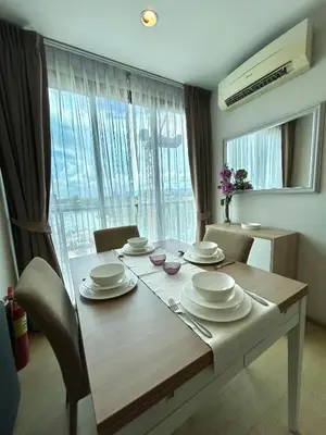 a dining room table with plates and dishes on it at 2 bedrooms Condos in Bangtao in Bang Tao Beach