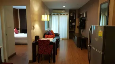 a kitchen and living room with a refrigerator and a table at Phuket Villa Patong in Patong Beach