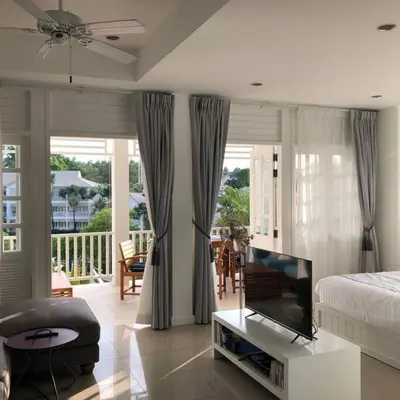 a bedroom with a bed and a tv in a room at Ocean breeze studio 1 bed in Ban Pak Lak