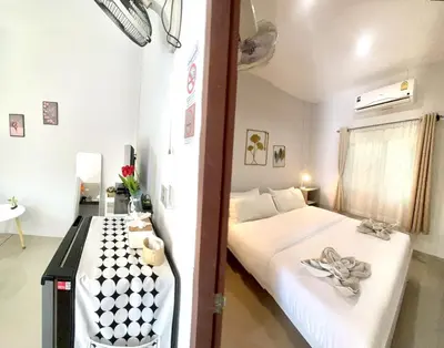 a bedroom with a bed and a table in it at Yada House s&h in Nai Yang Beach