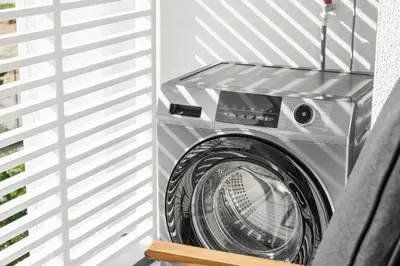 a washing machine in a room with a window at Title Halo Memories Naiyang Pool Gym Sauna in Nai Yang Beach