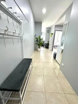 a hallway with a bench in a room at Apartment Karon SeaView 72 sq in Karon Beach