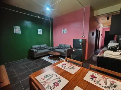 a living room with a couch and a table at Bonanza Patong Beach2 for 2 BR 100m to Beach Grace Room in Patong Beach